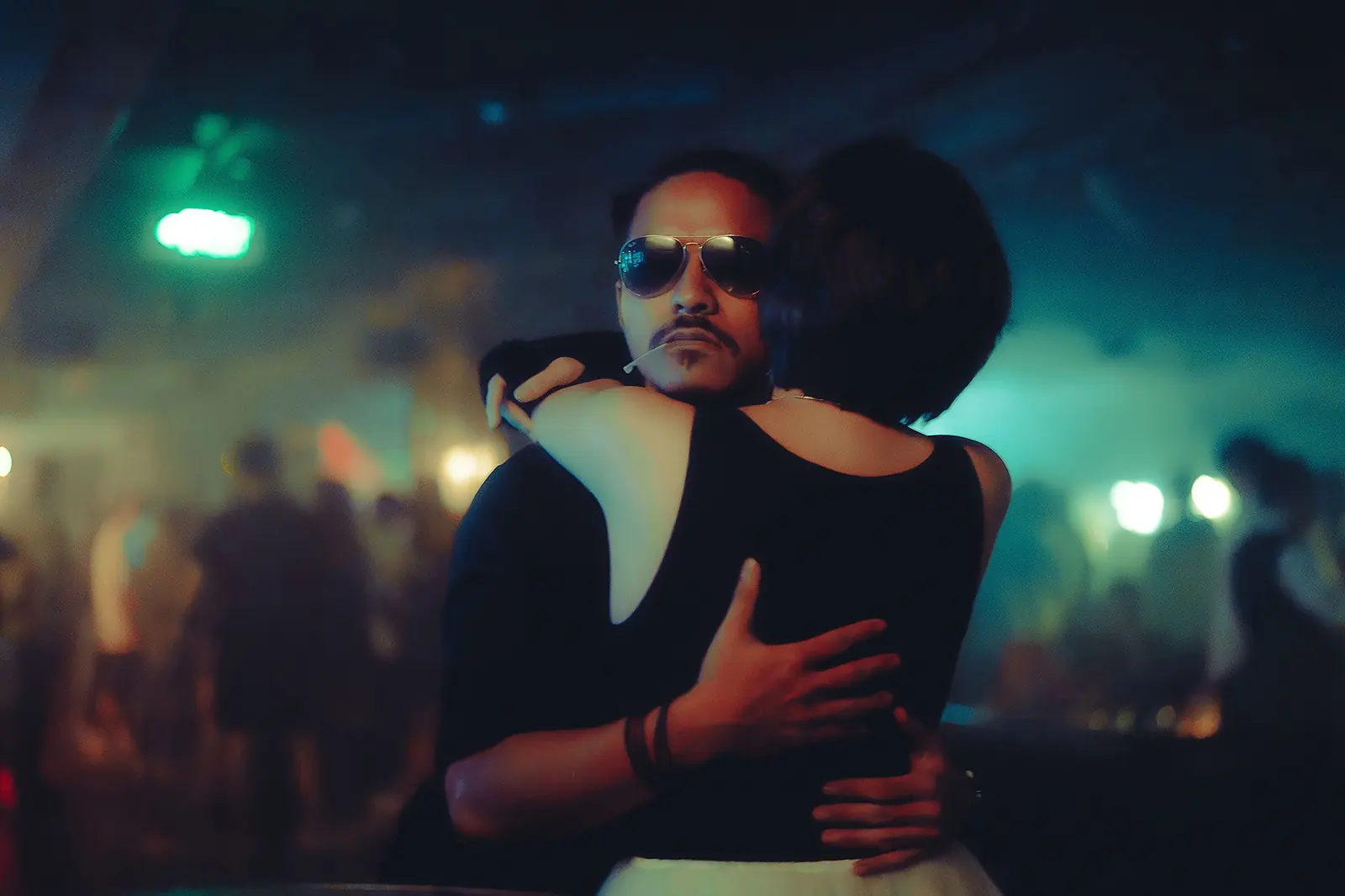 Illustrative stock image of an adult couple embracing in a nightclub