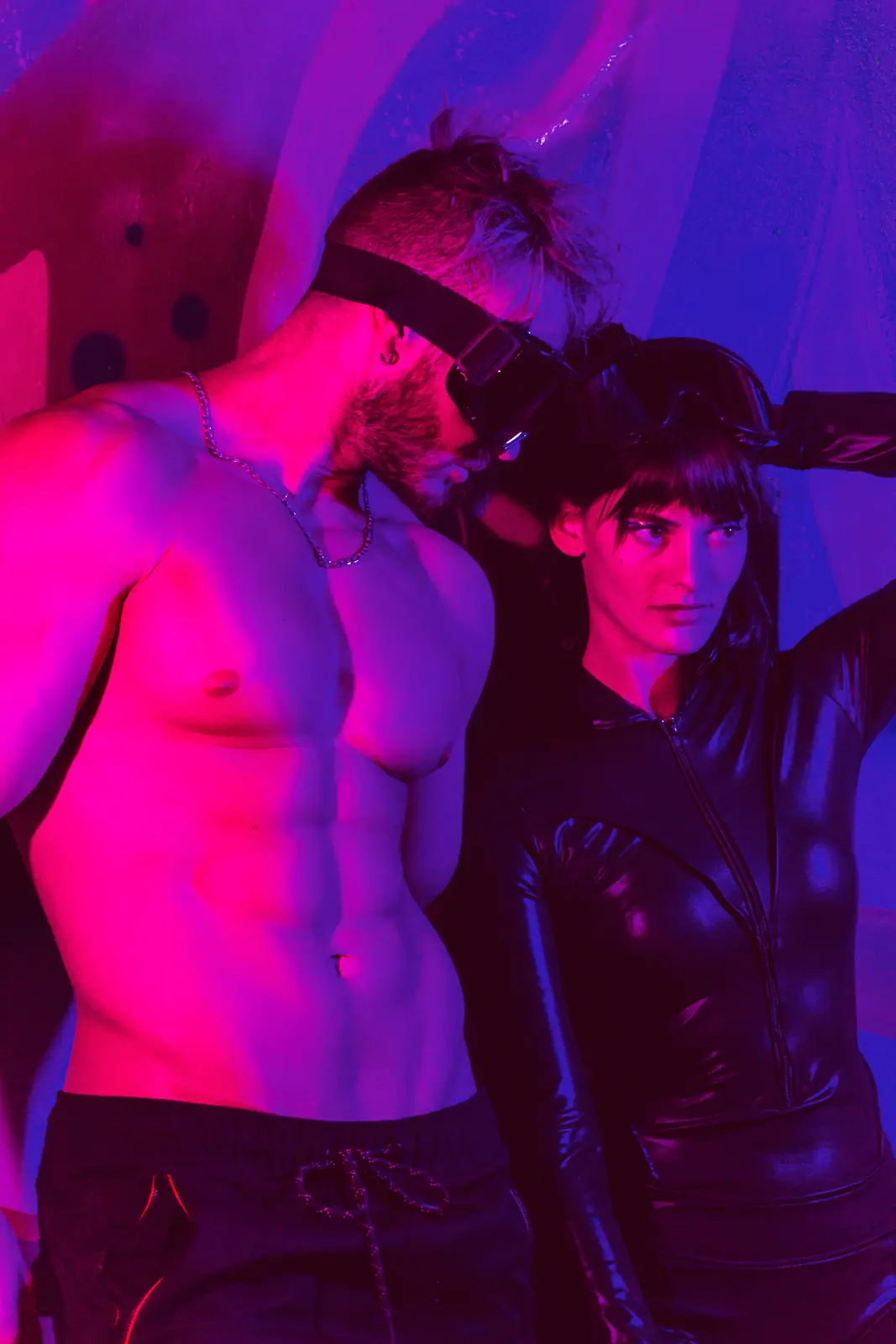 Illustrative stock image of an adult couple dancing in a purple nightclub